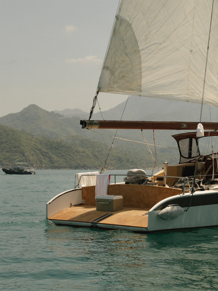 Private sailboat on Banderas Bay with green mountains behind