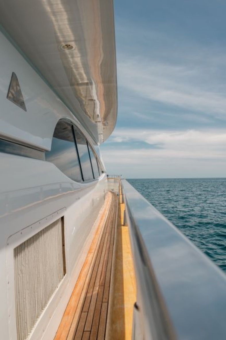 Teak side deck of a private motor yacht at sea
